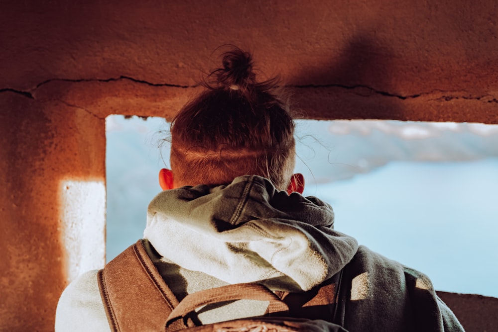 man in gray hoodie looking at the sky during daytime