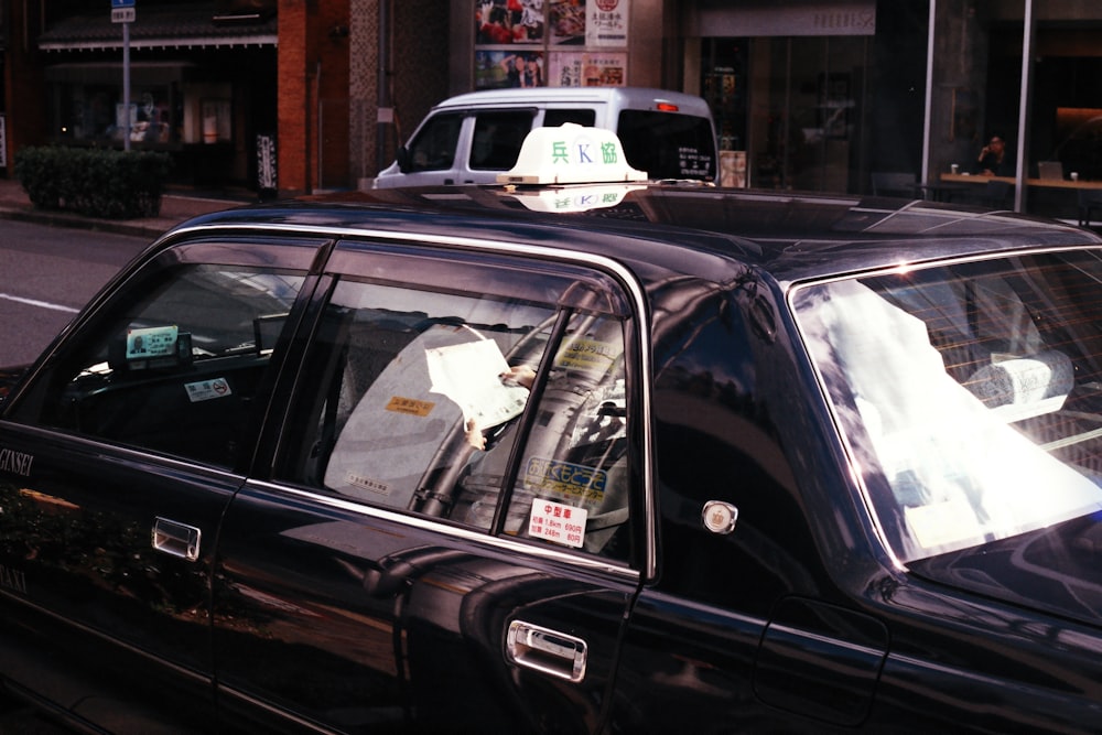 black car with white plastic bag on door