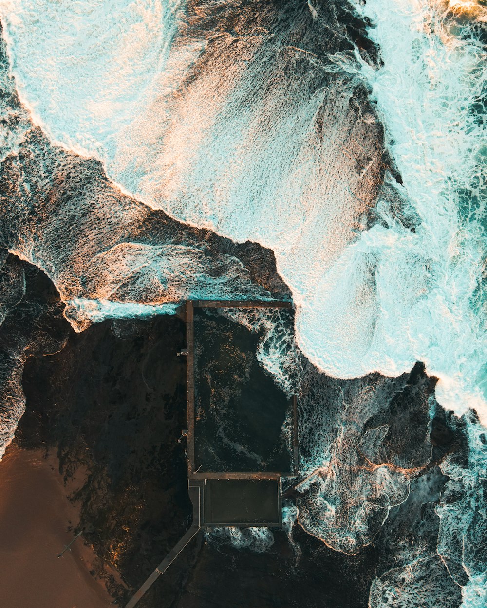 brown rock formation near body of water during daytime