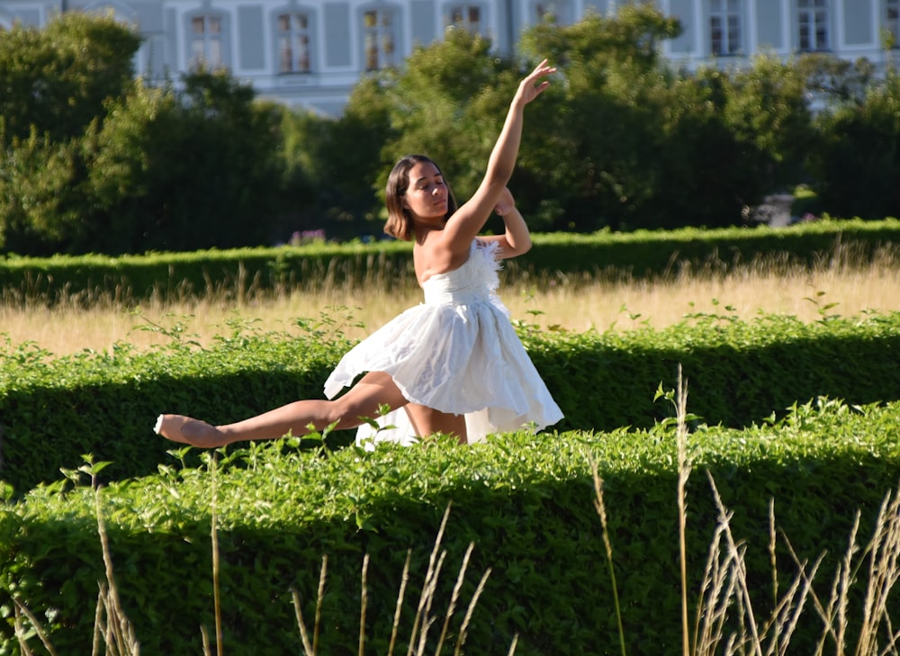 girl in white dress on green grass field during daytime