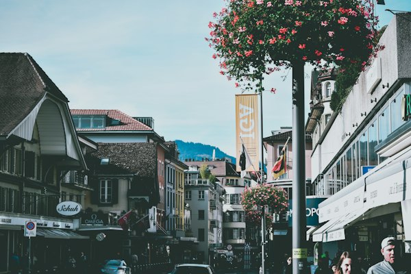 Cars parked beside the road near buildings during daytime — Interlaken & the Bernese Oberland, Switzerland