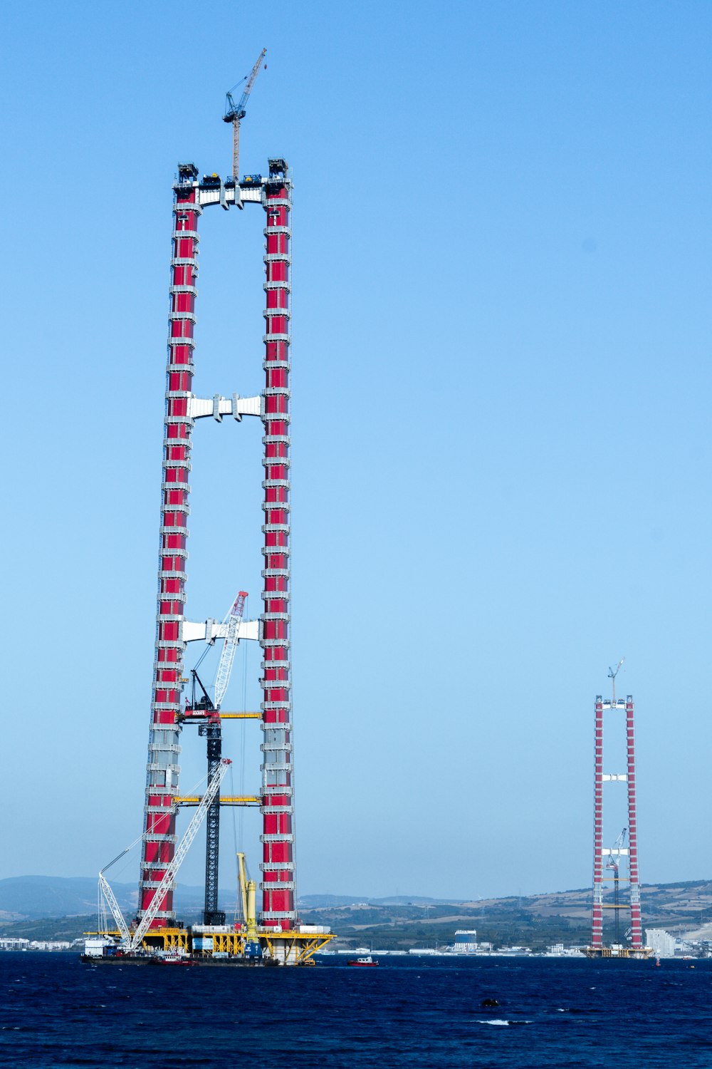 red and white metal tower under blue sky during daytime
