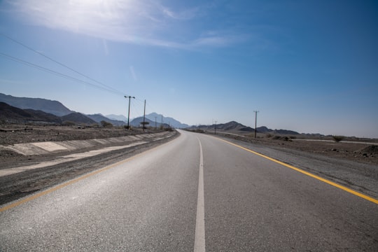 gray concrete road under blue sky during daytime in Hatta - Dubai - United Arab Emirates United Arab Emirates