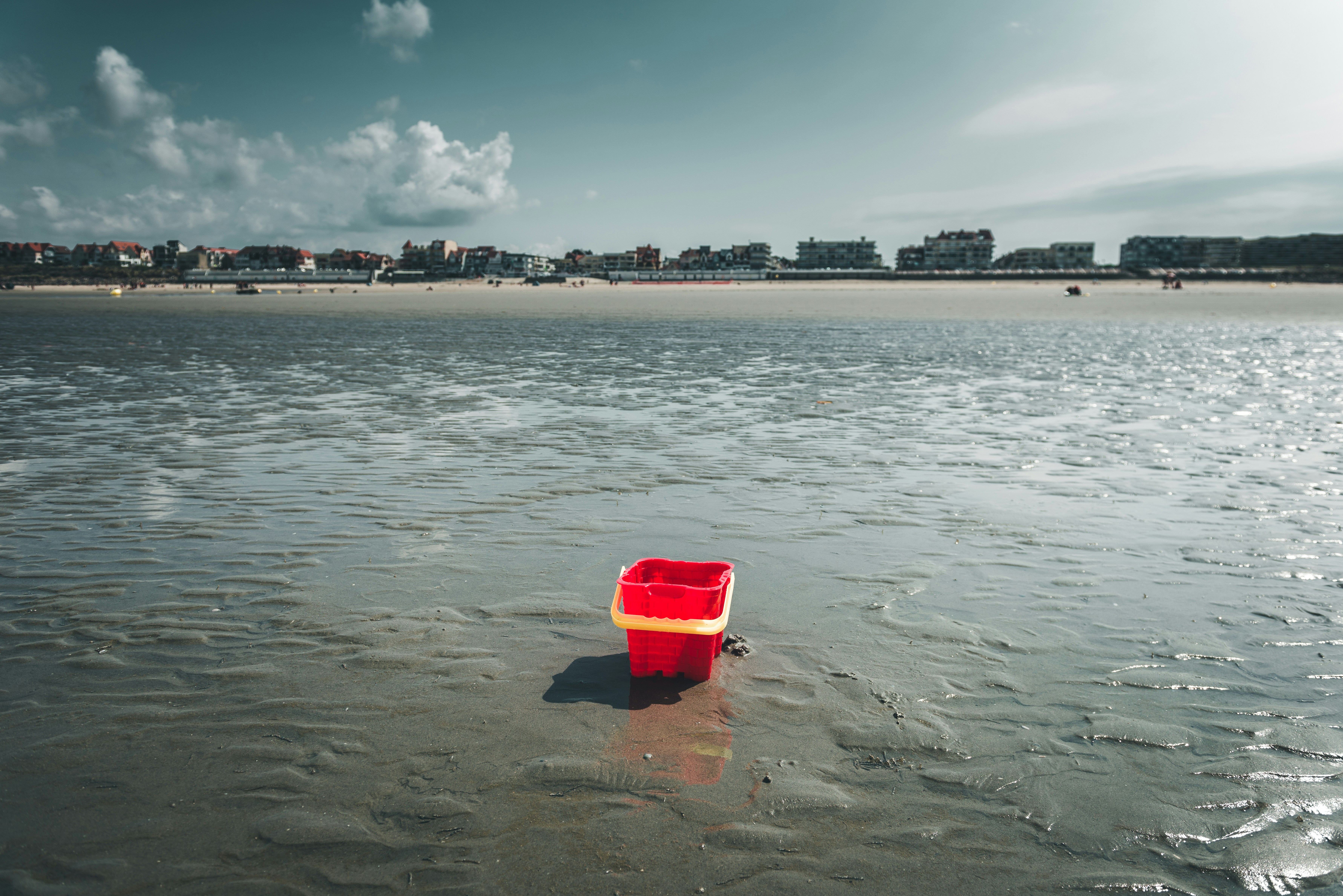 red plastic bucket on water