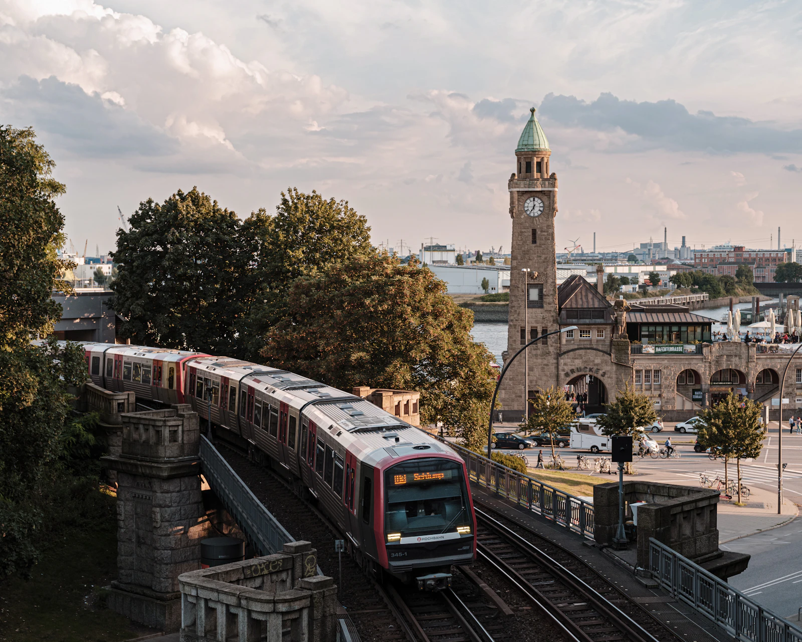 a U-Bahn train on the elevated line above the Landungsbrücken, the harbour behind it