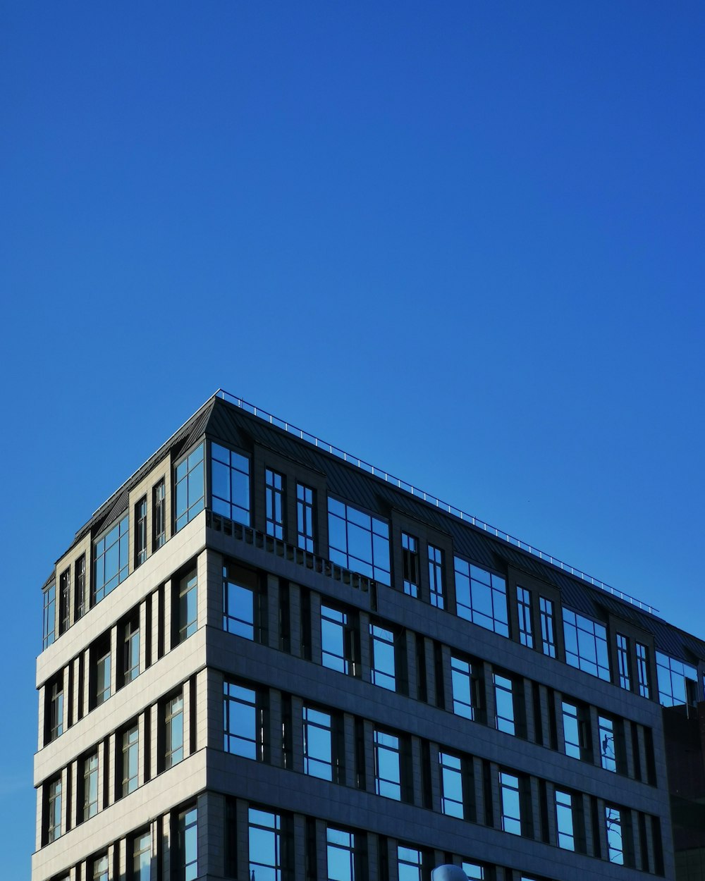 white concrete building under blue sky during daytime