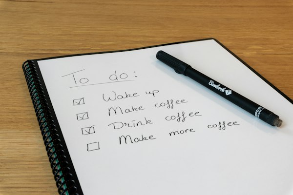 A notepad with a pen resting on it