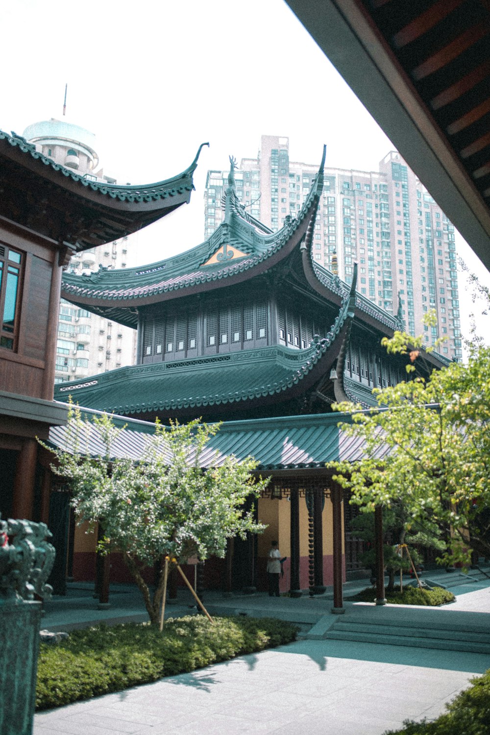 green trees near brown and black temple during daytime