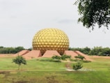 brown dome building on green grass field during daytime