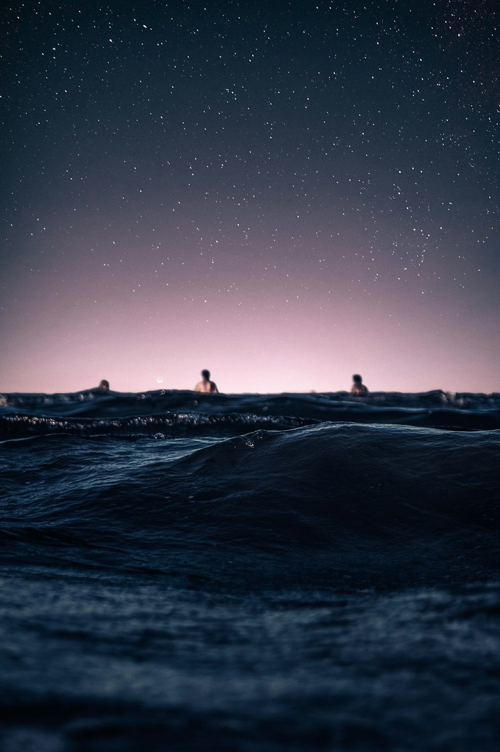 silhouette of people on beach during night time
