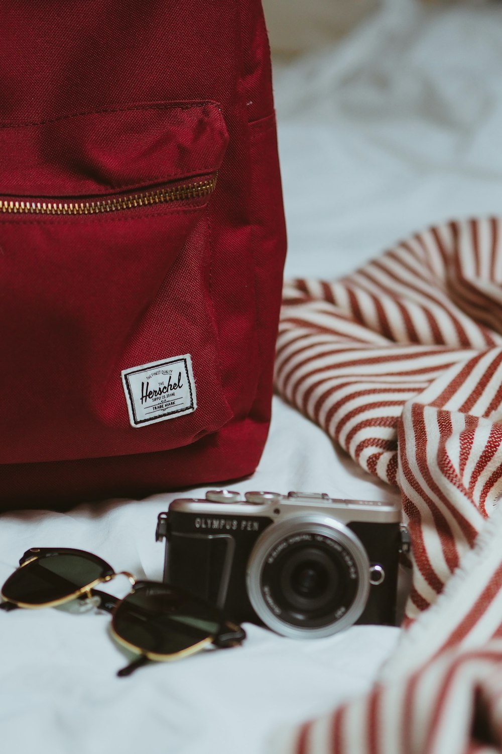 red and black camera on white and red striped textile