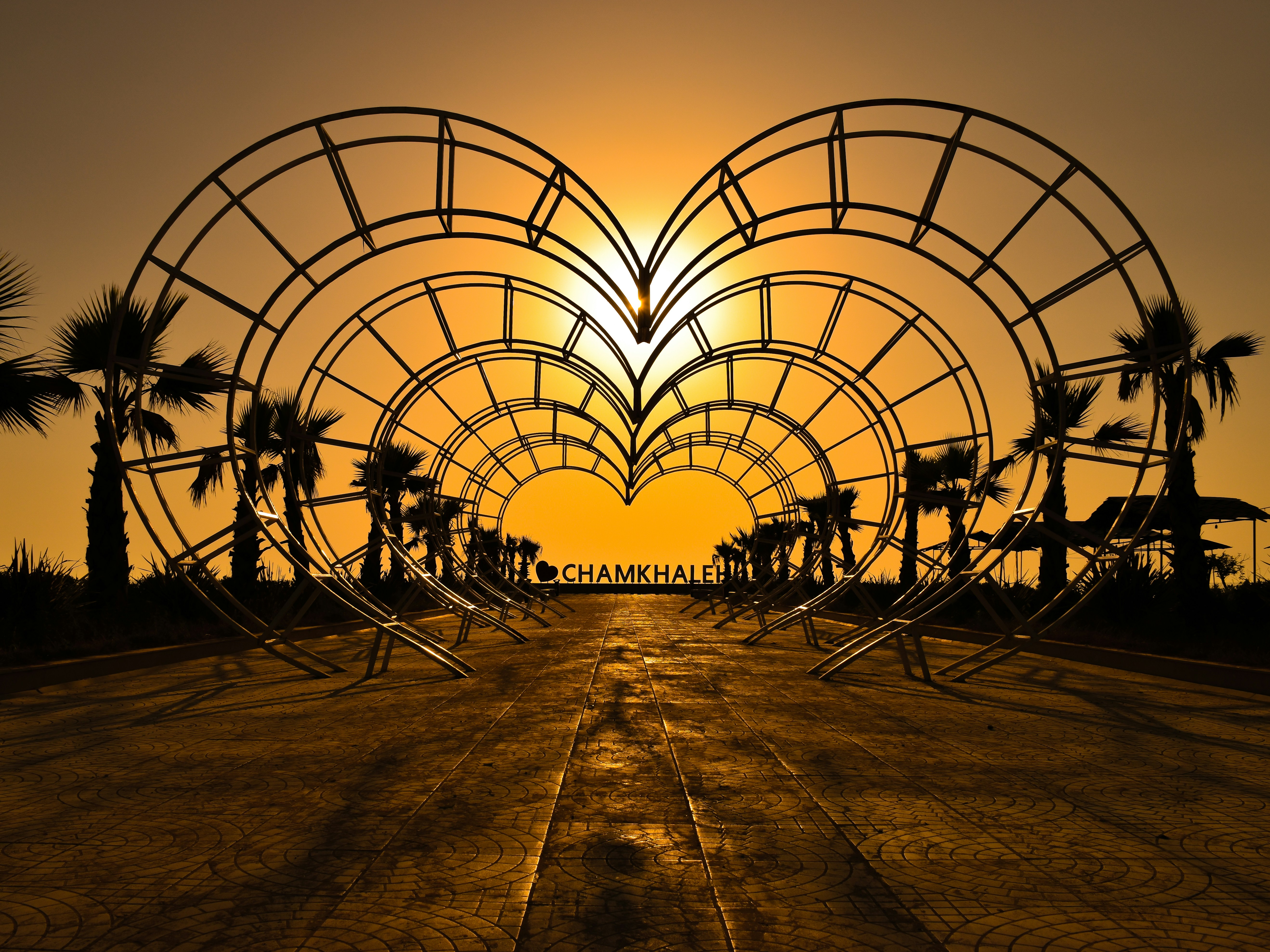 silhouette of people walking on brown sand during sunset