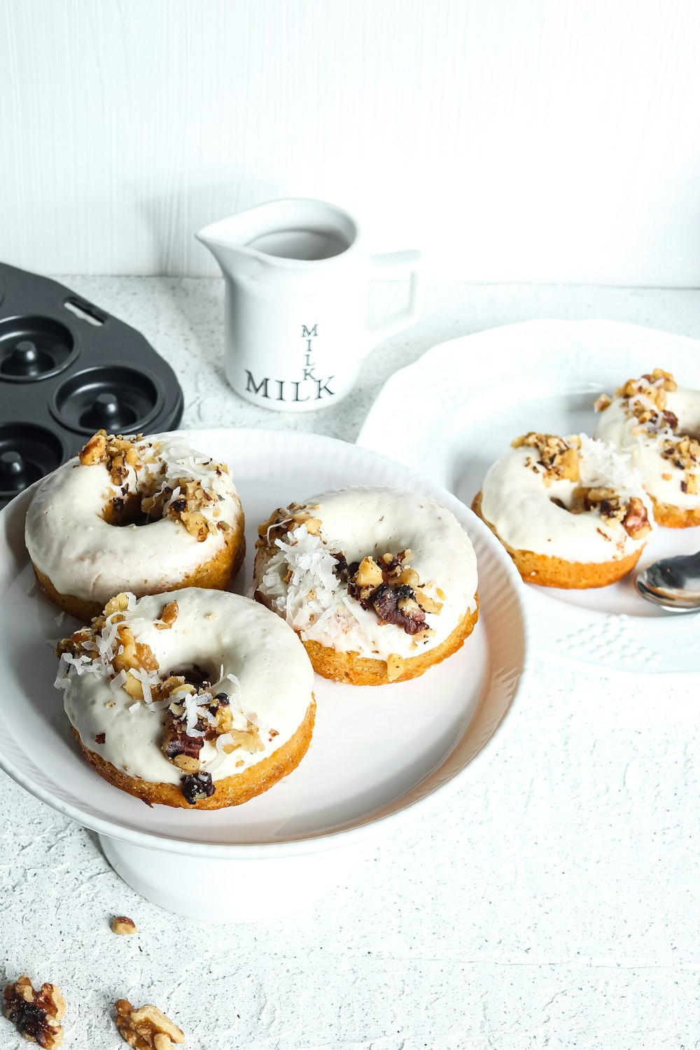three doughnuts on white ceramic plate