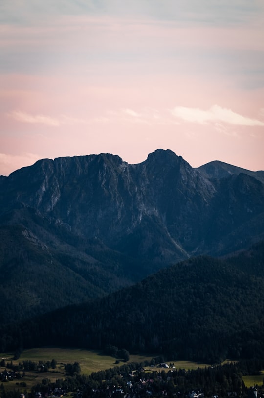 black and white mountains under white clouds during daytime in Giewont Poland