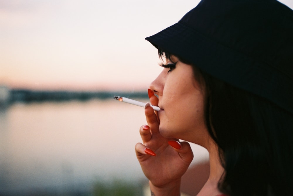 woman smoking cigarette during daytime