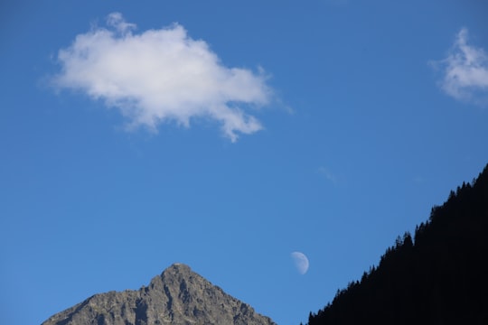 green trees and mountain under blue sky during daytime in Rohrmoos-Untertal Austria