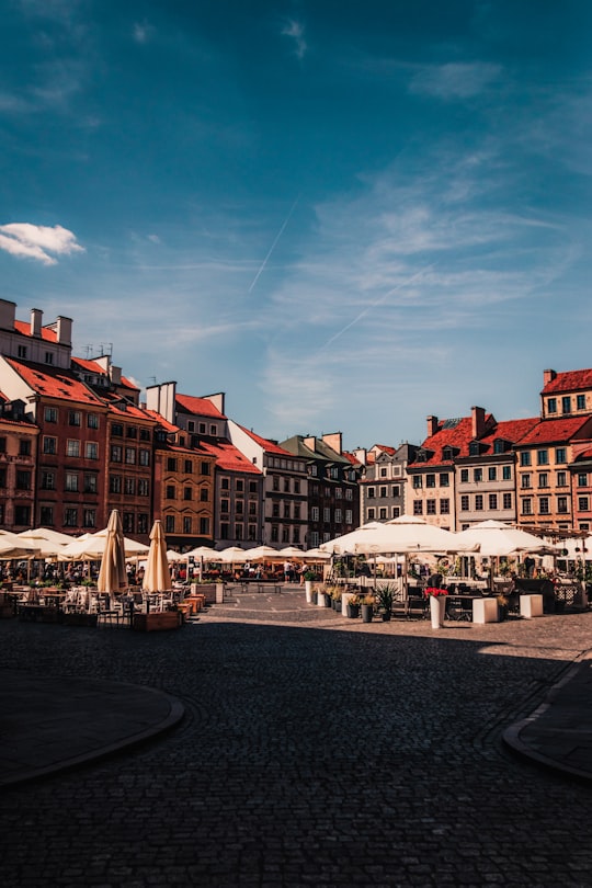 people walking on street near buildings during daytime in Old Town Market Square Poland