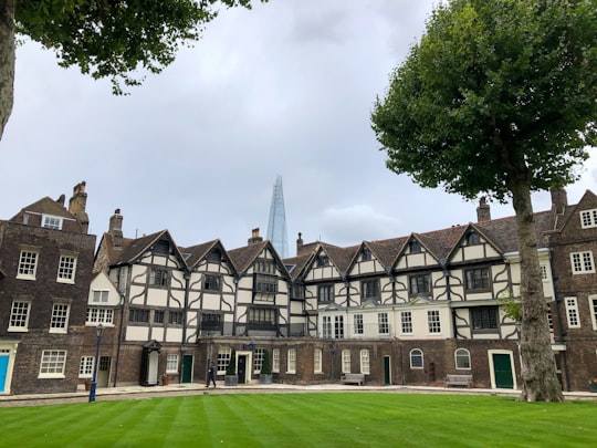 green grass field near green and brown concrete building during daytime in Tower of London United Kingdom