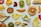 A collection of various dried fruit slices spread out on a white surface, including oranges, kiwis, peaches, pears, and strawberries. The arrangement showcases diverse shapes, textures, and vibrant colors.