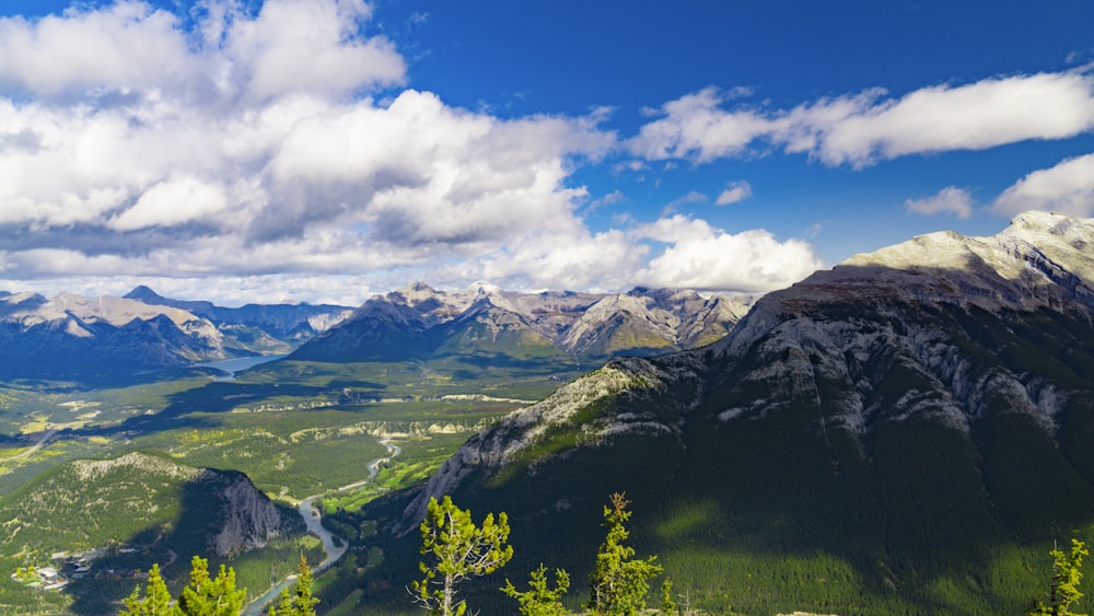 green and brown mountains under blue sky and white clouds during daytime