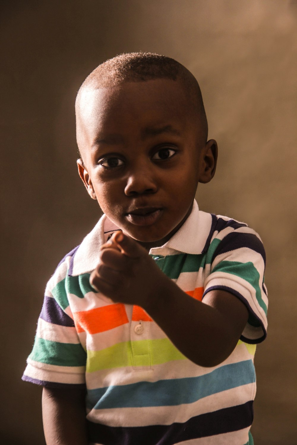 boy in white blue and red striped long sleeve shirt