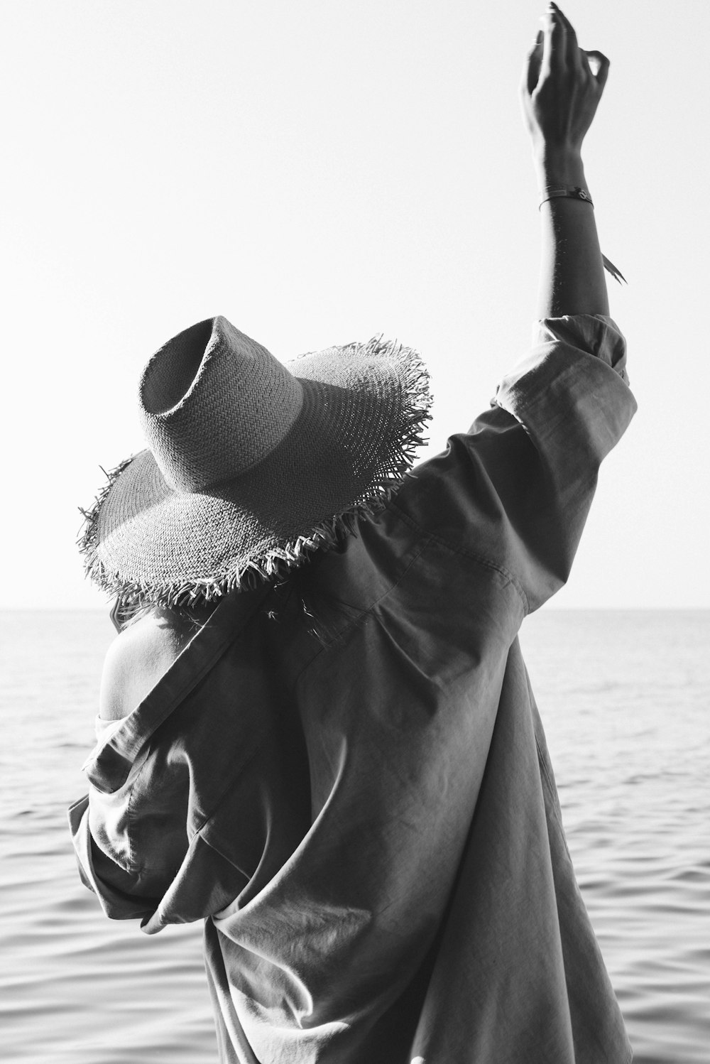 grayscale photo of woman wearing sun hat and sunglasses