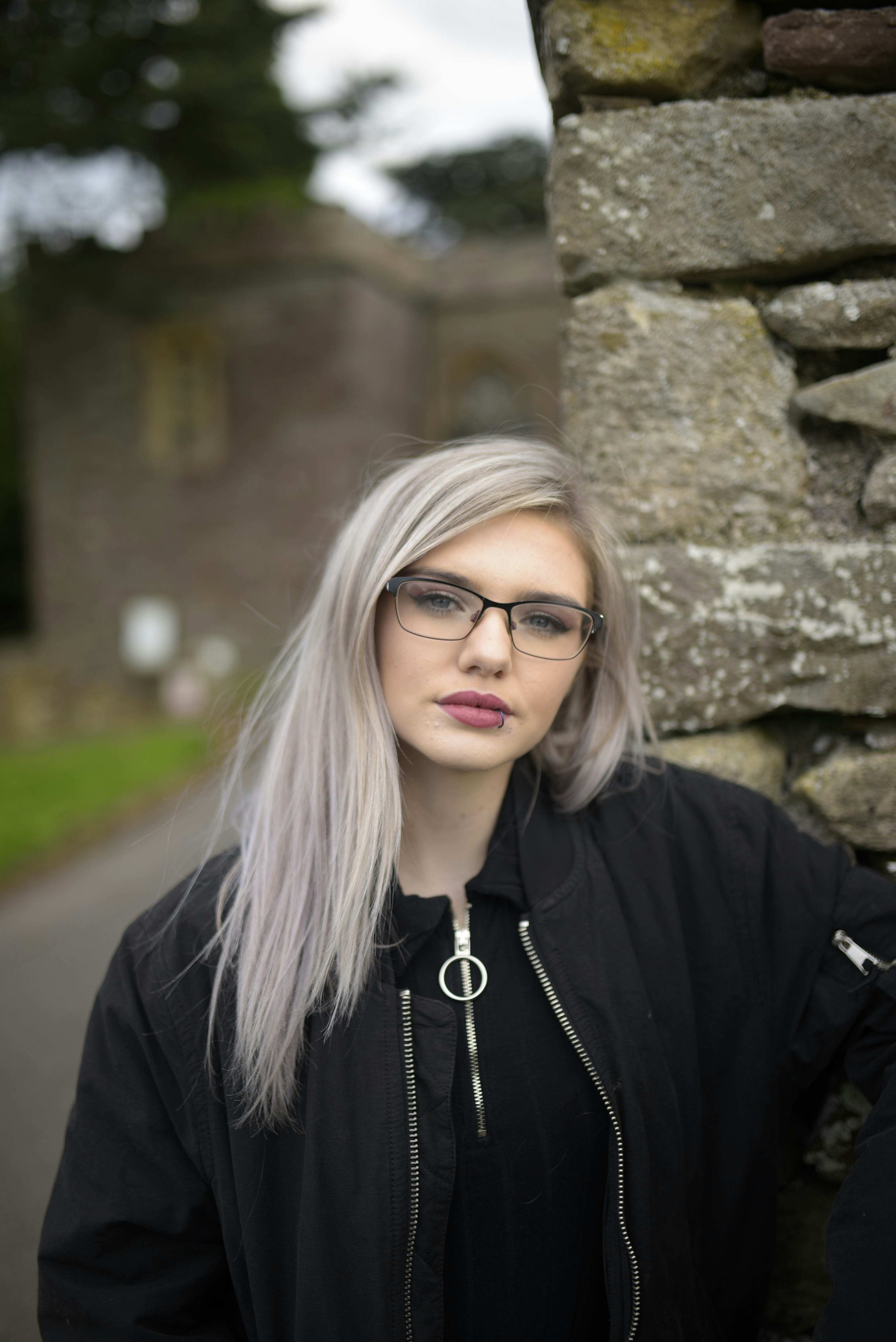 woman in black jacket wearing black framed eyeglasses