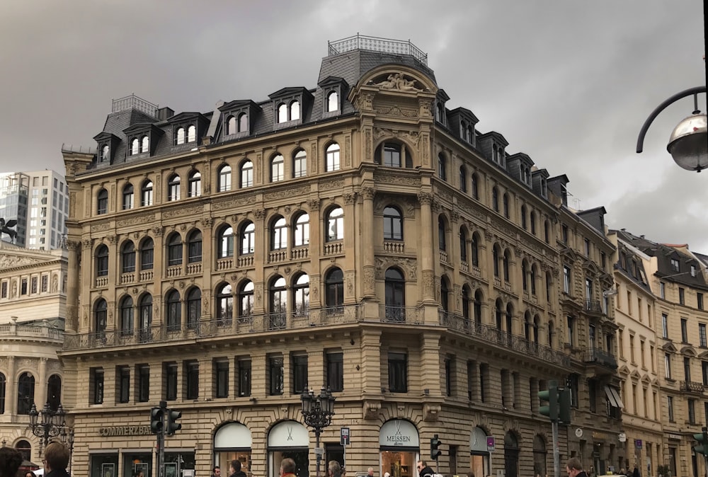 brown concrete building under white clouds during daytime