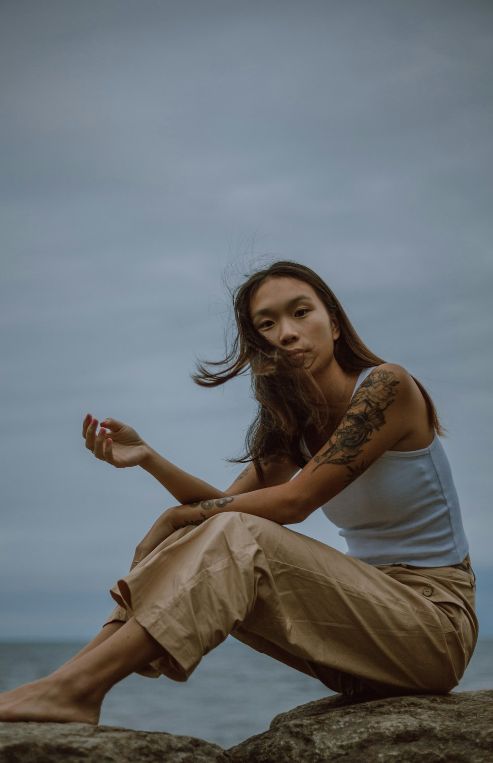 woman in white tank top and beige skirt