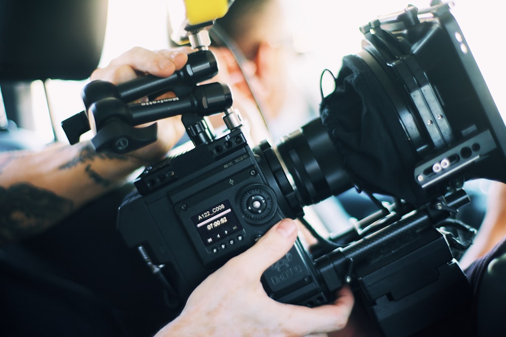 person holding black video camera