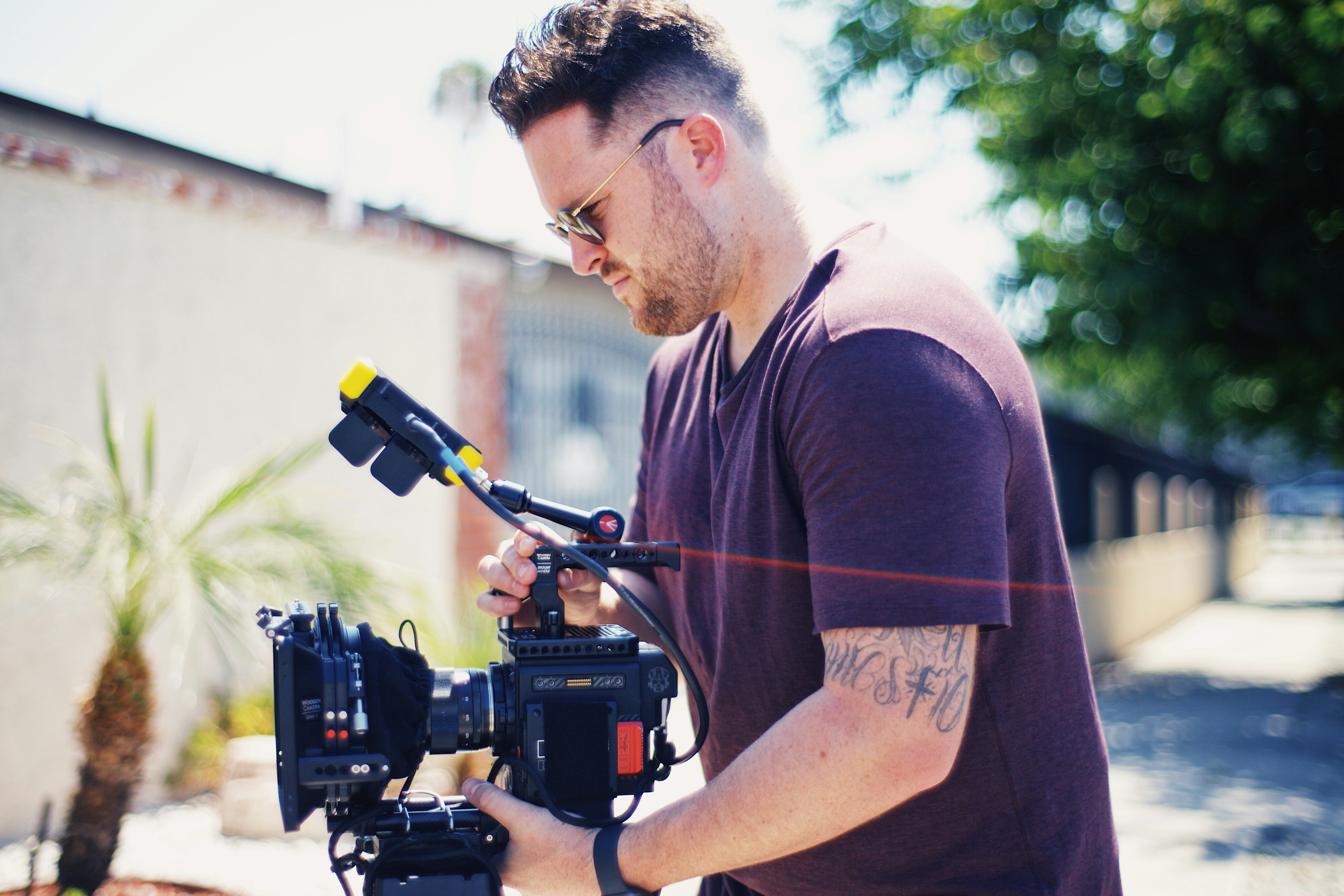 a man holding a camera on a tripod