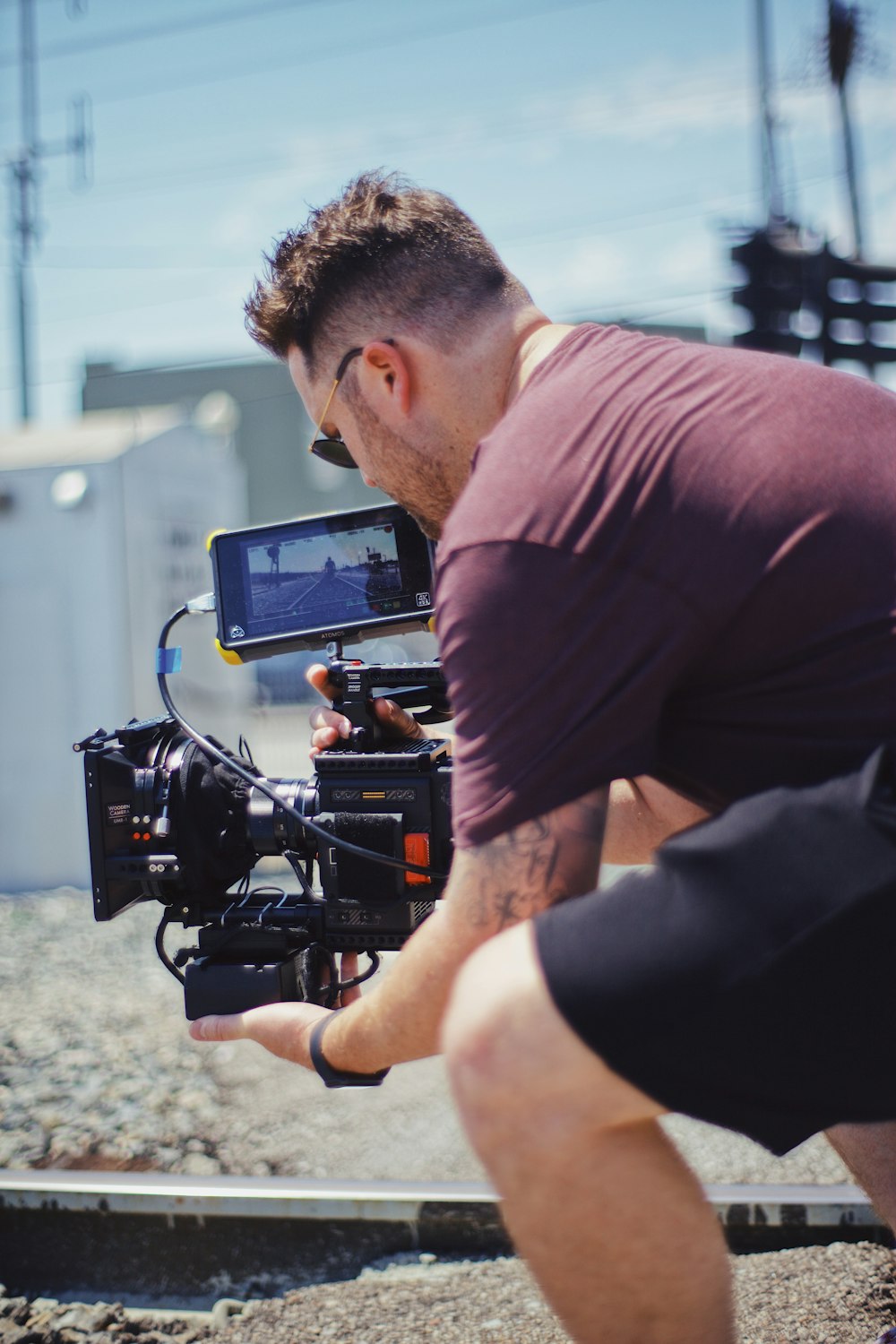 man in black t-shirt holding black video camera