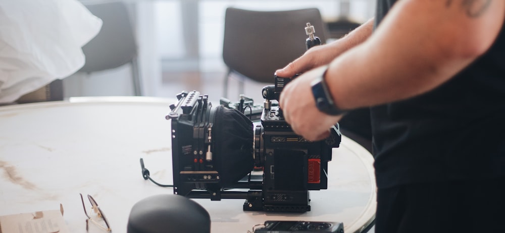 person holding black video camera