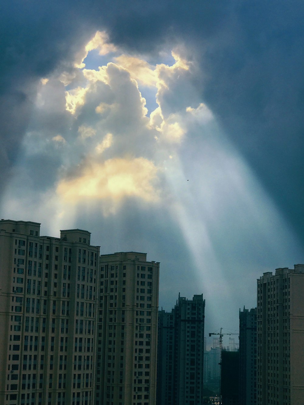 white clouds over city buildings during daytime