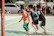 A lively team-building event with colleagues engaged in a fun interactive activity outdoors.