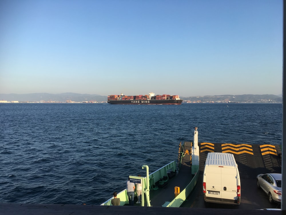 white and green ship on sea during daytime