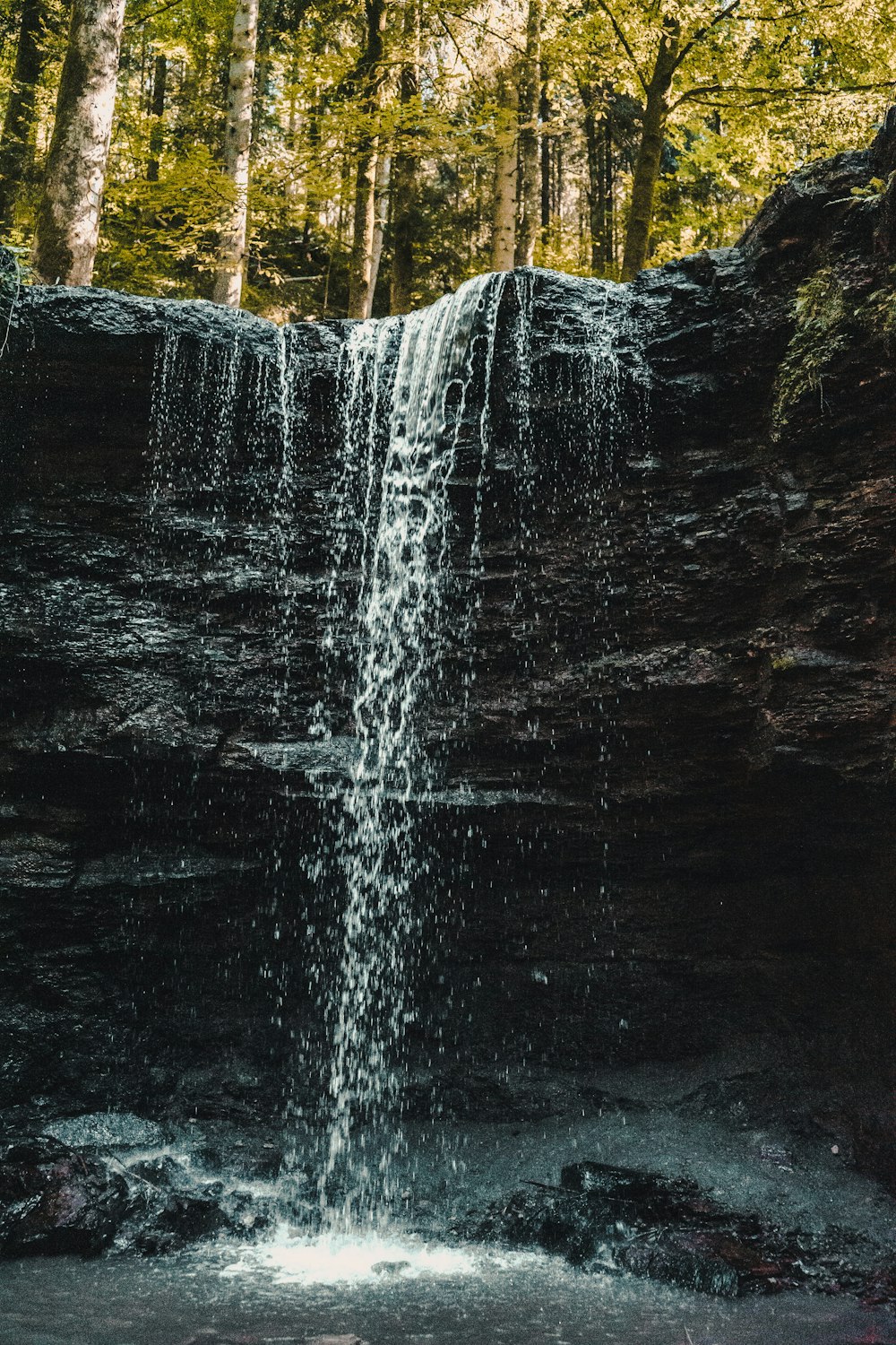 water falls on rocky mountain