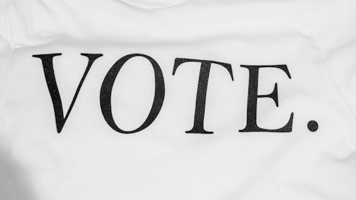 Bold black lettering spells out the word 'VOTE.' on a plain white background. The typography is simple and clear, conveying a direct message.