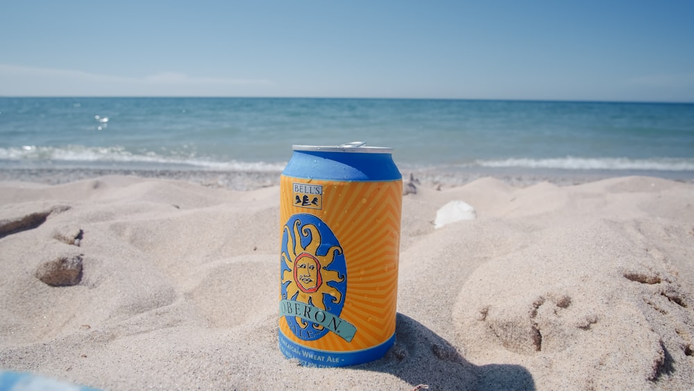 fanta orange can on beach during daytime