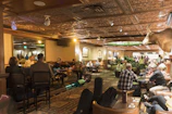 Cozy bistro bar warmly lit with guests enjoying live music