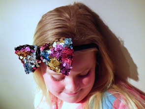 A cheerful headband adorned with a large, colorful bow.