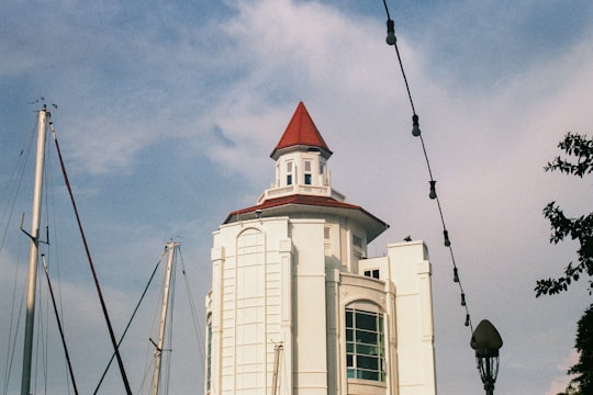 white and red concrete building under blue sky during daytime in Penang Malaysia