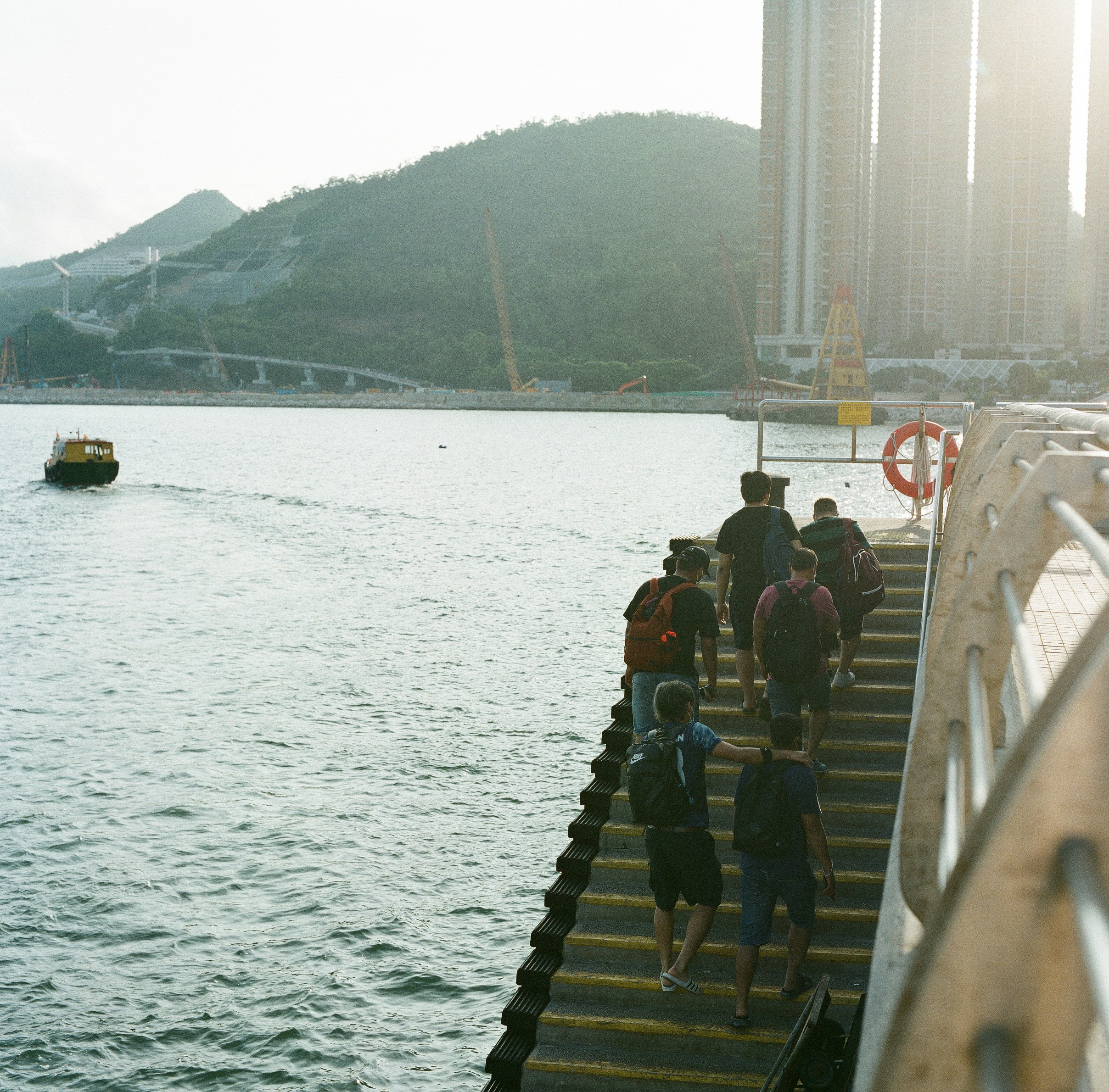people sitting on wooden dock during daytime