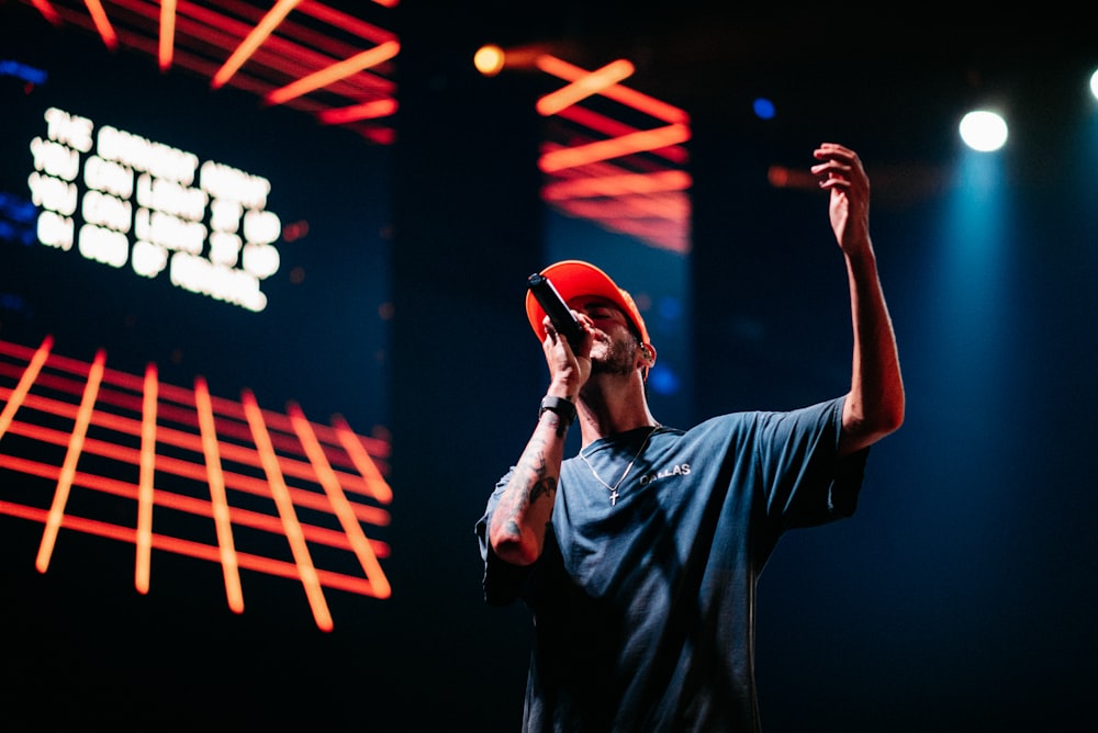 man in blue crew neck t-shirt wearing red cap