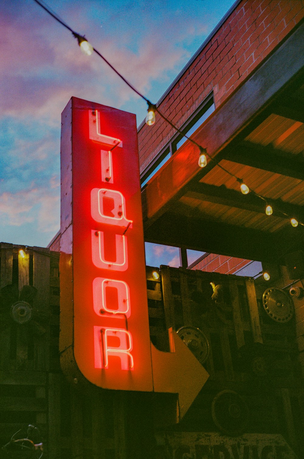 a red neon sign that is on the side of a building