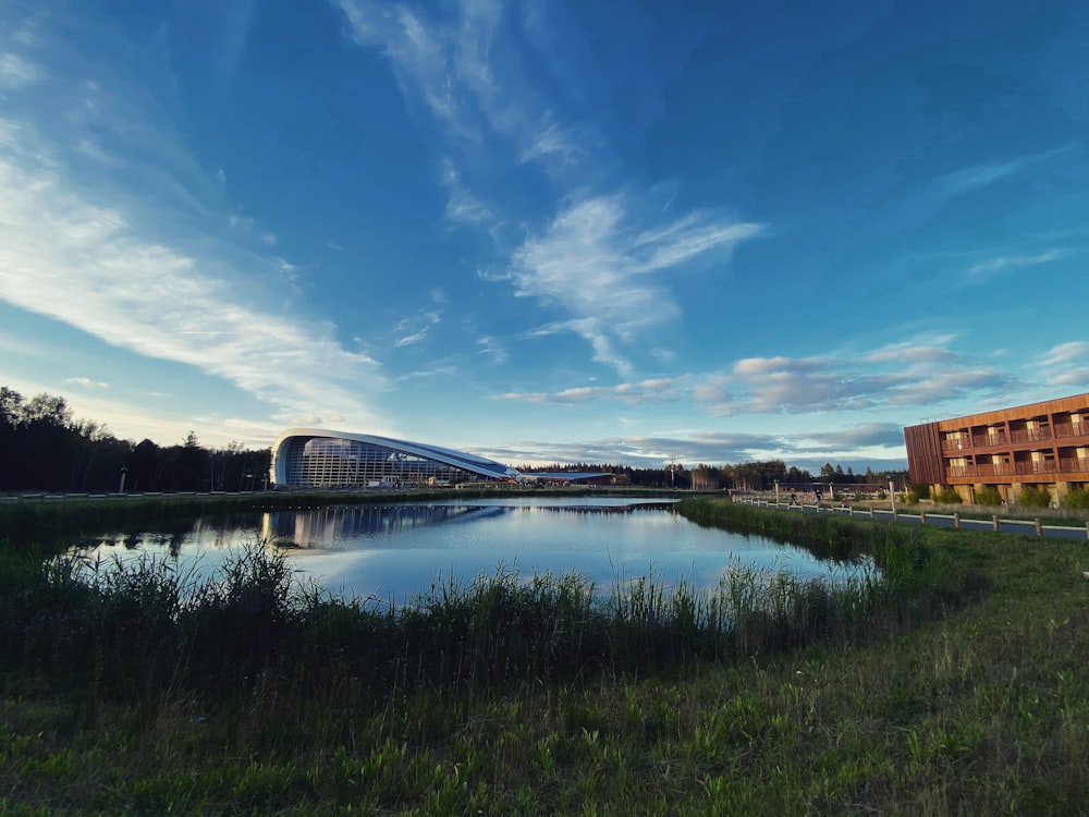 brown wooden bridge over river under blue sky during daytime