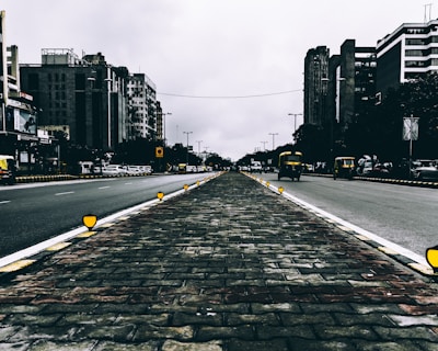 A wide shot of a busy intersection in Mumbai featuring clear, crisp road markings and signs.