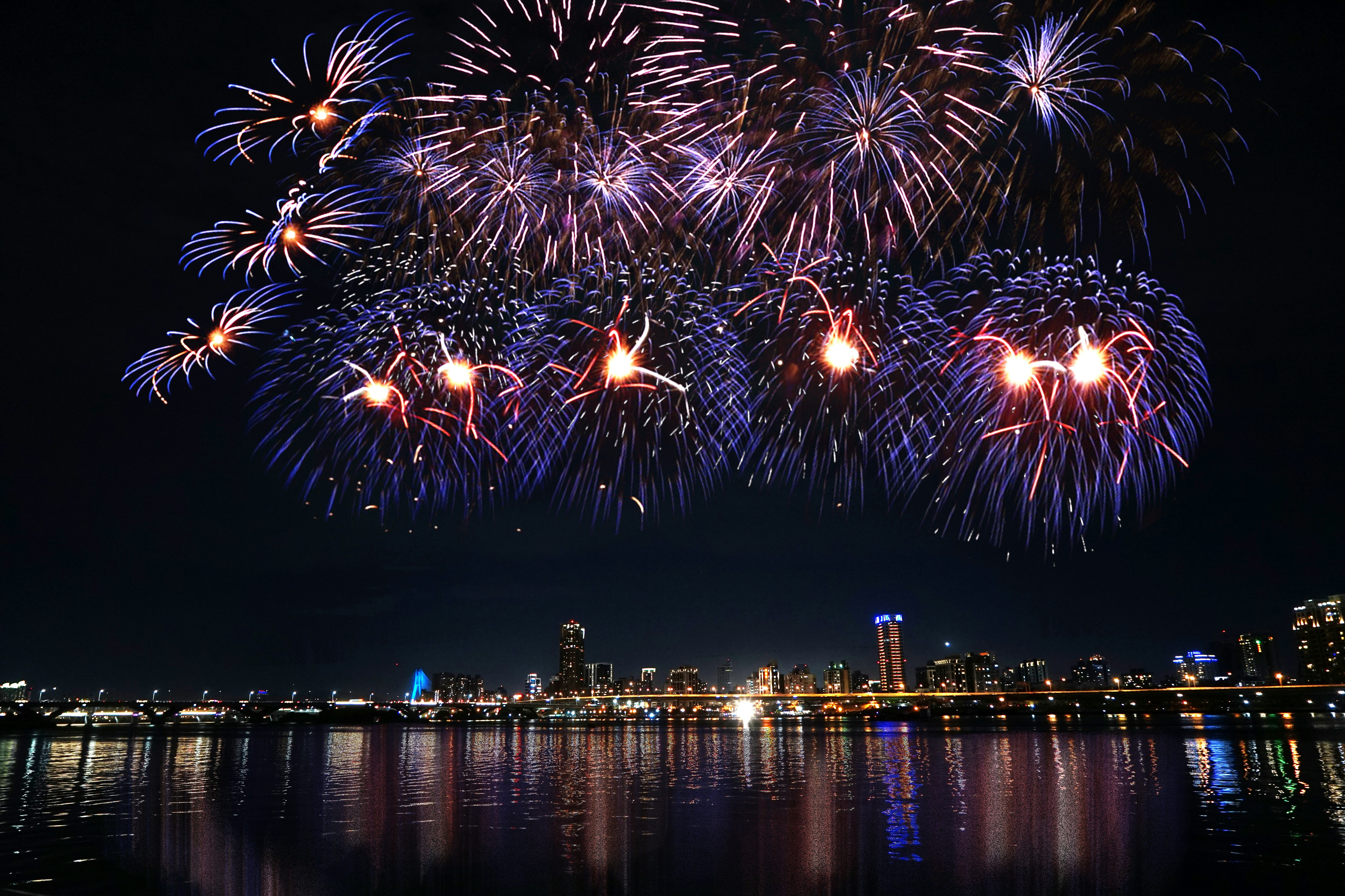 Fireworks Display Over City Buildings During Night Time Photo Free Image On Unsplash