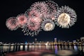 fireworks display over city buildings during night time