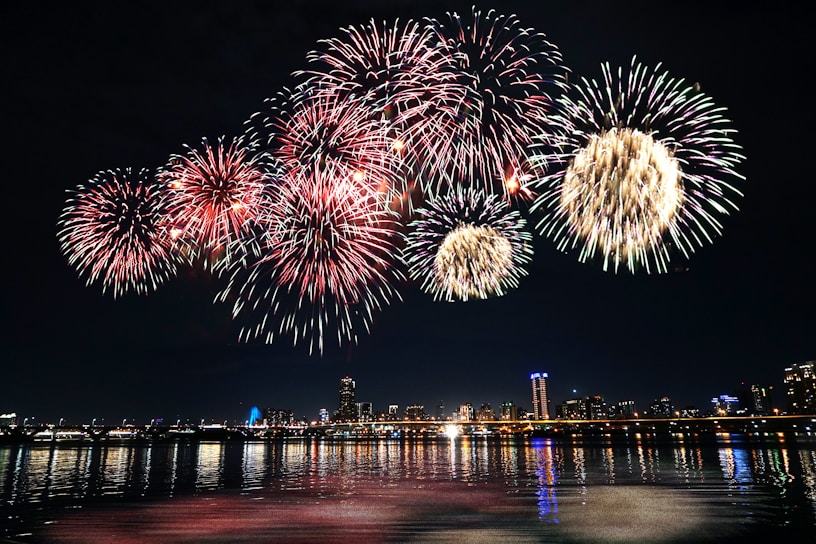 fireworks display over city buildings during night time